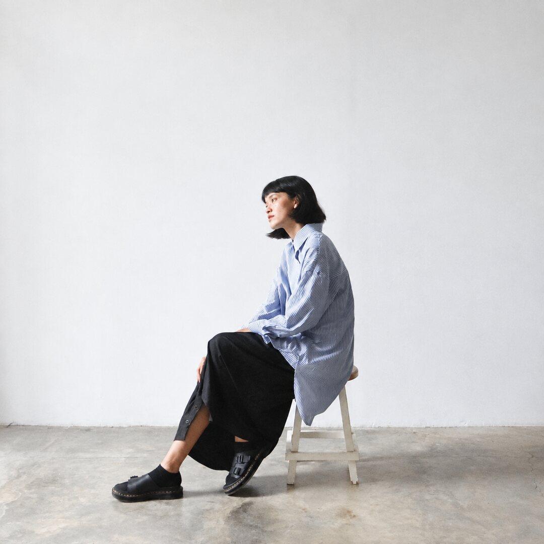 A woman taking a thoughtful pause on a chair