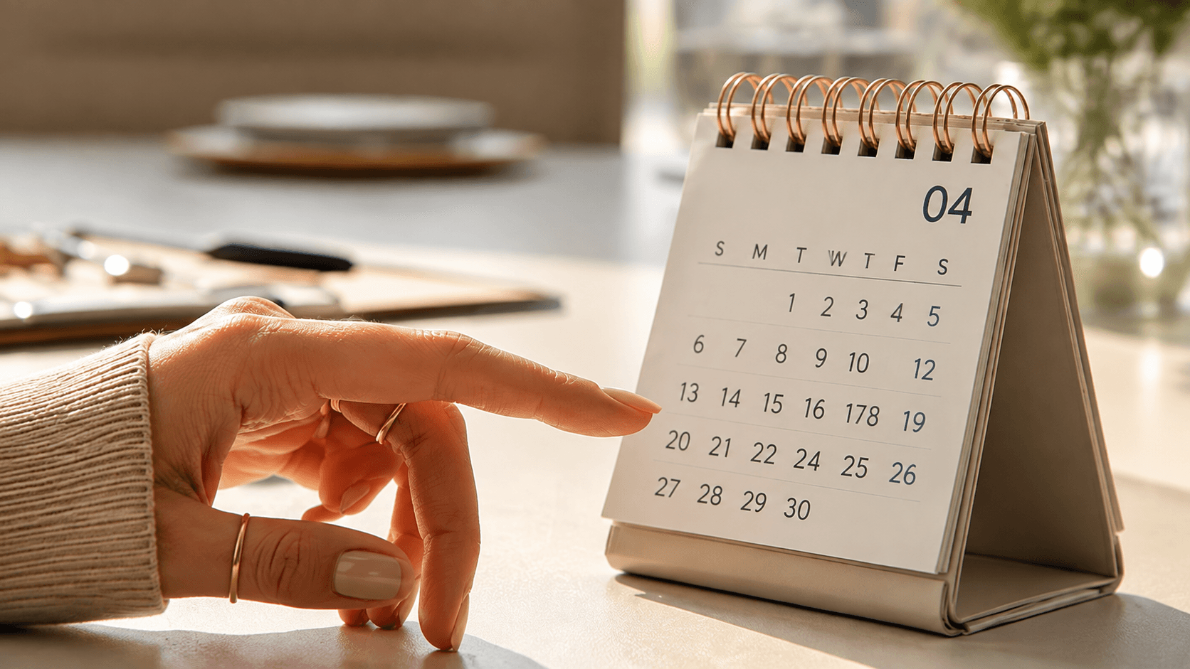 Hand pointing at a desk calendar