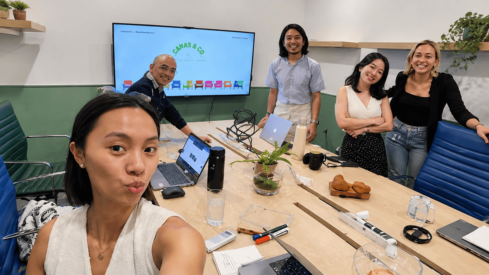 Team gathered around a desk working together