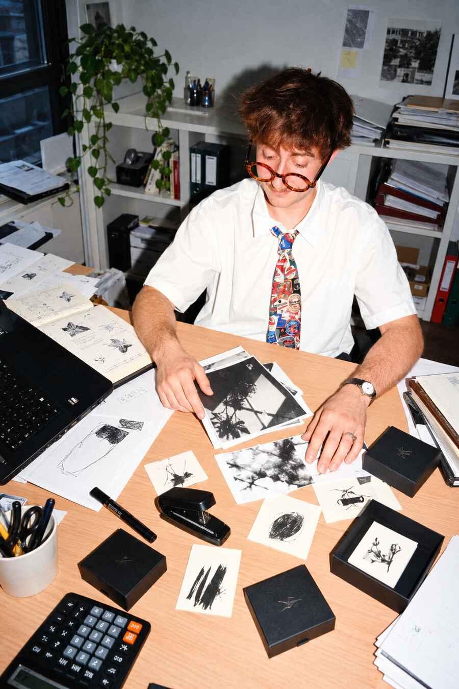 Creative professional reviewing photographs at a desk